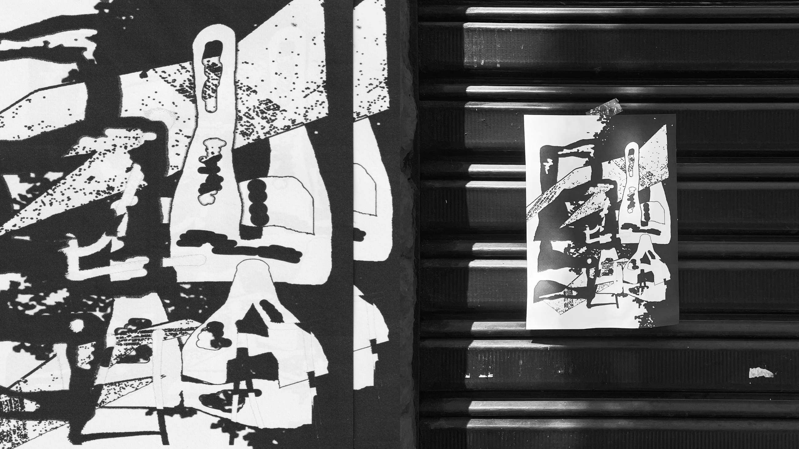 Printed graphic collage taped to a metal shutter alongside its original artwork