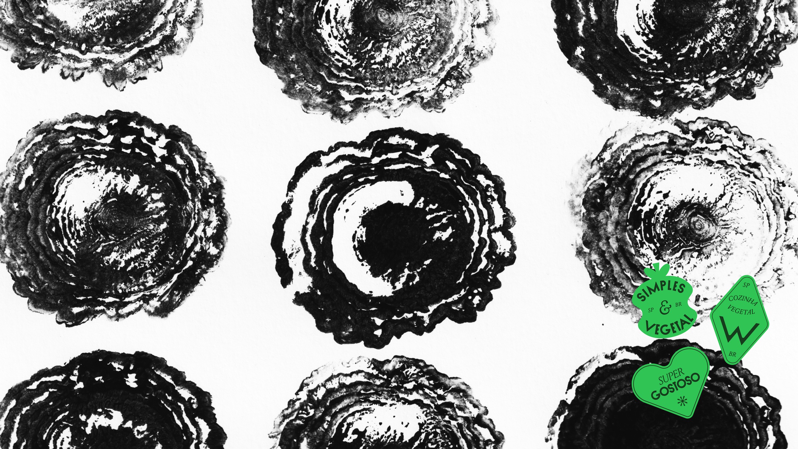 Stamped prints of halved vegetables in black, with green brand stickers over them